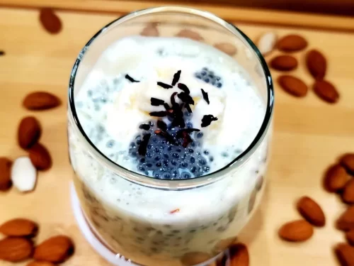 Rabri Faluda is a luscious dessert drink layered with silky rabri, soaked basil seeds, and vermicelli, topped with nuts for a rich and refreshing indulgence.
