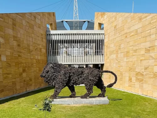 Regional Science Center in Bhopal, Madhya Pradesh, featuring a creative metal lion sculpture in the courtyard against modern architecture, an educational attraction included in Madhya Pradesh tour packages.