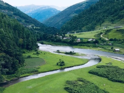 Sangati Valley scenic green valley with winding river and lush hills creating a picturesque landscape in Arunachal Pradesh Tour Package.
