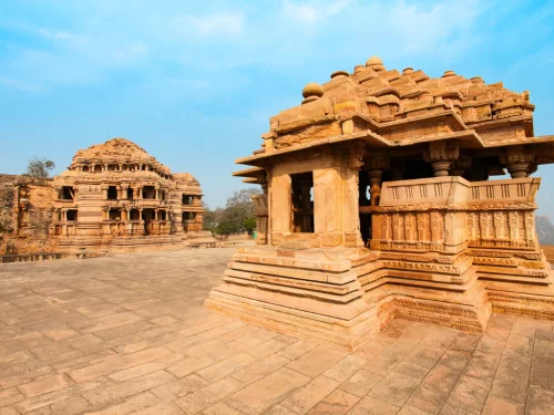 Sasbahu twin temples at Gwalior Fort under clear skies, featuring intricate carvings and elevated shrines, perfect heritage experience with Madhya Pradesh tour packages.