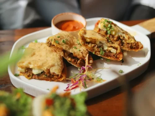 Sha Phaley is a crispy Tibetan-style deep-fried bread stuffed with juicy spiced meat, offering a delightful crunch with every flavorful bite.