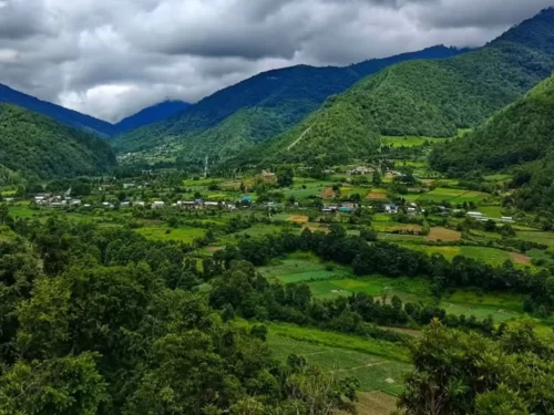 Shergaon Heritage Village picturesque rural settlement surrounded by lush green valleys and scenic mountains in Arunachal Pradesh Tour Package.