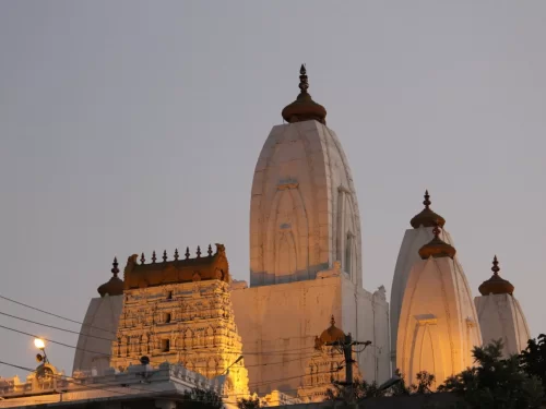 Shri Omkareshwara Swamy Temple at Madikeri Coorg during golden sunset, featuring white shikharas and dome architecture, perfect spiritual Coorg tour package.