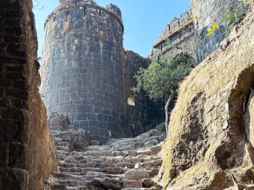 Sinhagad Road Pune. Scenic route leading to historic Sinhagad Fort with rugged hills and stone pathways.