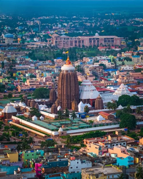 Aerial view of Jagannath Temple complex in Puri Odisha surrounded by colorful cityscape highlighting cultural heritage in Odisha tour packages