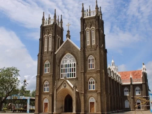 St. Andrew's Roman Catholic Basilica, Gothic-style church with twin towers and stained glass windows in Kerala