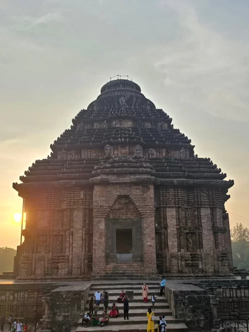 Front view of Konark Sun Temple in Odisha during golden sunset showcasing magnificent stone architecture in Odisha tour packages
