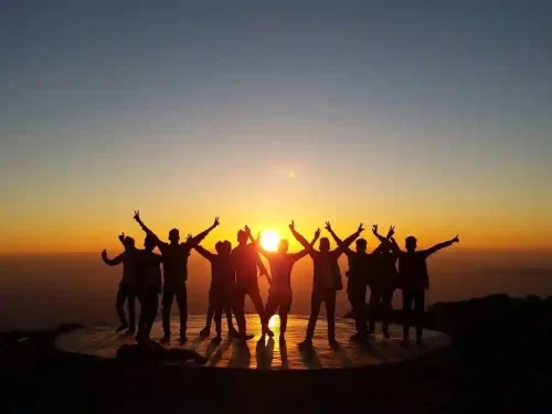 Sunset Point Mount Abu Popular hilltop lookout featuring tiered stone seating, a panoramic view of the Aravali Range, and the sun dipping below the desert horizon Rajasthan.