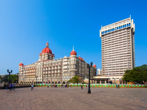 Taj Mahal Palace Mumbai heritage Palace Wing Taj Tower modern extension Gateway of India tourists blue sky, perfect Colaba luxury tour package.