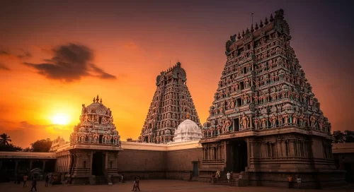 Meenakshi Temple at Madurai during sunset, featuring colorful gopurams and sculptures, perfect romantic Tamil Nadu tour package.