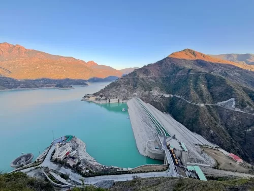 Tehri Dam in Tehri, Uttarakhand overlooking the vast turquoise reservoir and surrounding hills, a major engineering landmark featured in Uttarakhand tour packages