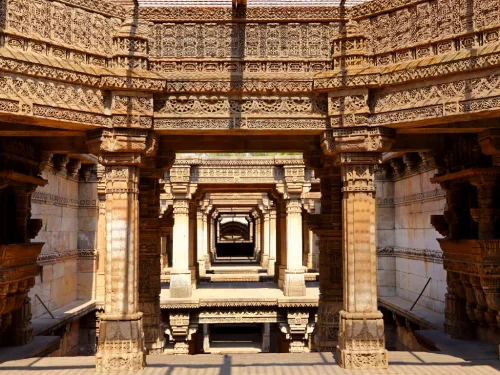 Intricate stepwell at Adalaj Stepwell during daylight, featuring carved pillars and multi-level arches, perfect cultural Gujarat tour package.