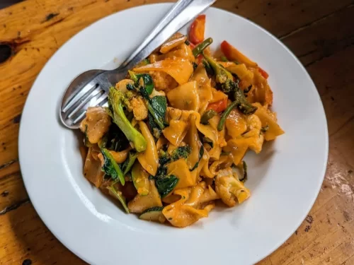 Thenthuk is a hearty Ladakhi hand-pulled noodle dish tossed with fresh vegetables and aromatic spices, delivering comforting flavors in every bite.