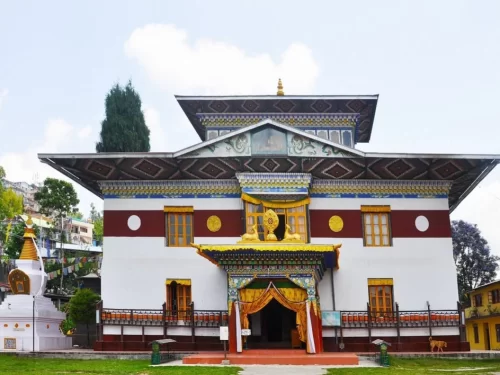 Thongsa Gompa in Kalimpong, West Bengal, featuring traditional Bhutanese-style architecture with colorful wooden windows and ornate entrance, a significant Buddhist monastery included in West Bengal tour packages.
