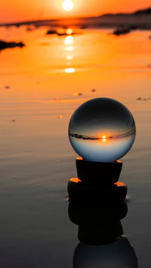 Stunning sunset at Mandvi Beach Gujarat reflected through a crystal ball on the shoreline creating a serene coastal view featured in Gujarat tour packages