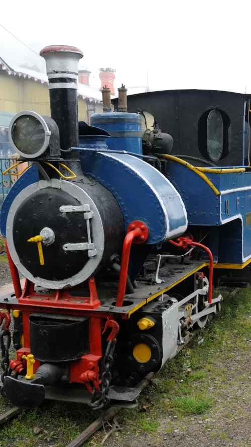 Historic Darjeeling Himalayan Railway steam engine at the hill station platform, an iconic attraction included in West Bengal tour packages.