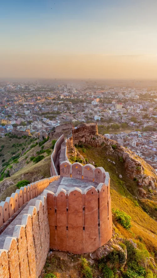 Nahargarh Fort Jaipur Rajasthan at sunset, featuring Aravalli hills and city skyline views, perfect heritage experience Rajasthan tour package 
