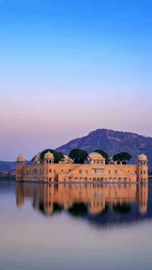 Jal Mahal Jaipur Rajasthan at sunset, featuring palace reflection in Man Sagar Lake, perfect romantic experience Rajasthan tour package