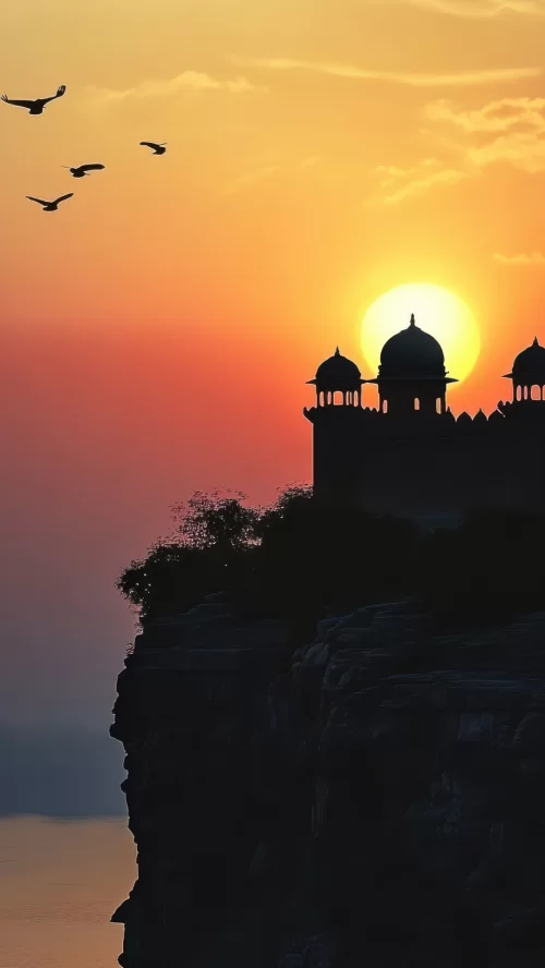 Chittorgarh Fort sunset view in Rajasthan with silhouetted domes and birds, perfect heritage experience Rajasthan tour package 