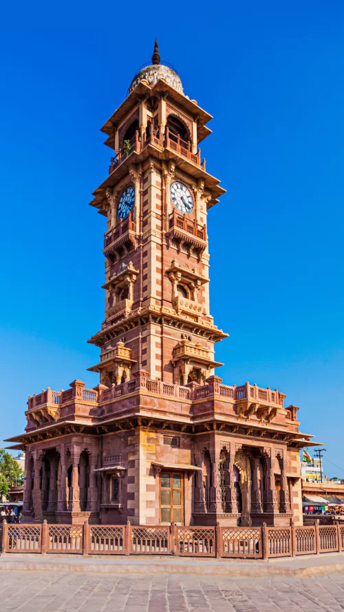 Ghanta Ghar Clock Tower in Jodhpur Rajasthan during clear blue sky, featuring sandstone carvings, perfect heritage experience Rajasthan tour package