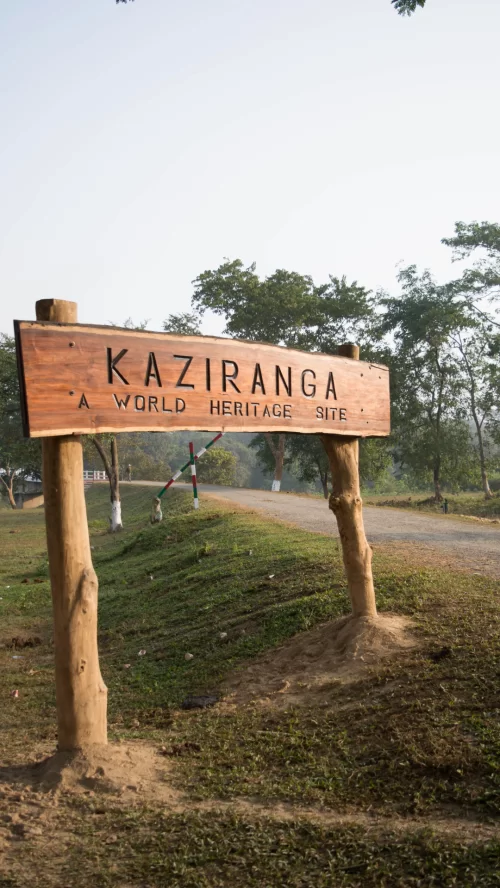 Wooden entrance sign of Kaziranga National Park Assam marked as World Heritage Site welcoming visitors through Assam tour packages
