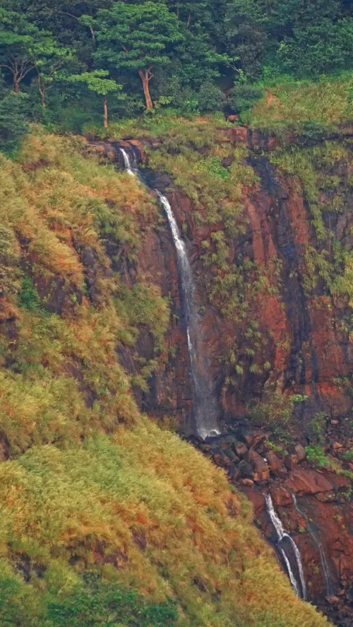 Louisa Point Matheran scenic waterfall cascading down lush green Sahyadri cliffs viewpoint in Maharashtra India Maharashtra tour packages