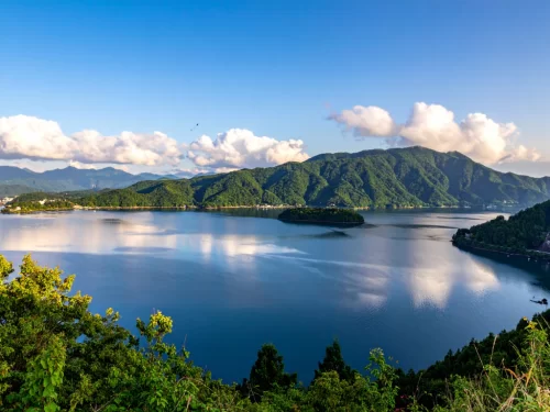 Valvan Lake View Point expansive turquoise lake forested emerald mountains islands clouds blue skies, perfect Lonavala Maharashtra nature tour packages.