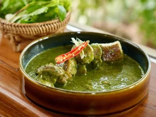 Wak Pura is a traditional Kashmiri delicacy of tender duck pieces simmered in a vibrant spinach gravy, delicately spiced and richly aromatic.