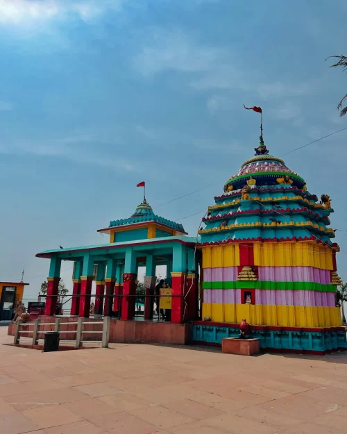 Colorful temple near Chilika Lake Odisha with vibrant architecture and clear blue sky featured in Odisha tour packages