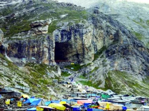 Amarnath Yatra cave shrine colorful tents pilgrims mountain backdrop, rocky entrance langars snowy slopes vibrant camps, perfect Jammu Kashmir spiritual ice lingam pilgrimage package.