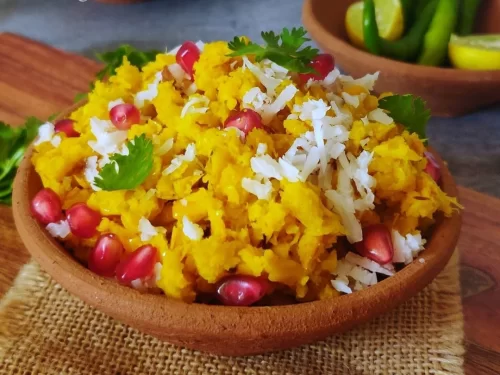 Bhutte ka Kees in creamy corn porridge with coconut and pomegranate garnish, authentic Indian Indori breakfast, steaming hot delight.