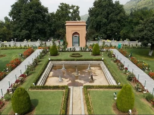 Chashme Shahi Srinagar aerial view Mughal pavilion central fountain terraced flower beds chinar trees Zabarwan backdrop featured in Kashmir tour packages