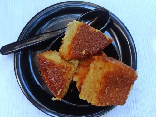 Chhena Poda baked cottage cheese cake in caramelized sugar syrup, authentic Indian Odia dessert, steaming hot delight.