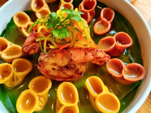 Chhutagi prawns in spicy coconut shell shells with cilantro garnish, authentic Indian Sikkimese delicacy, steaming hot delight.