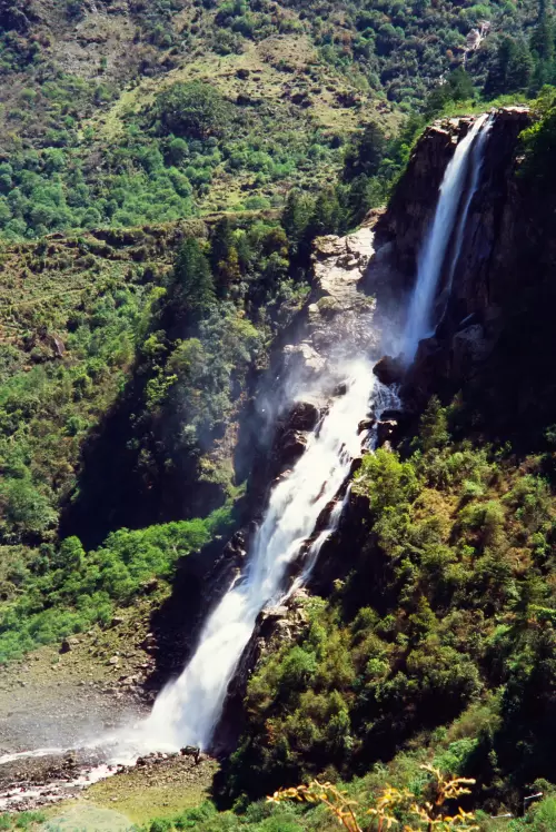 Scenic waterfall near Tawang in Arunachal Pradesh cascading through lush green mountains featured in Arunachal Pradesh tour packages