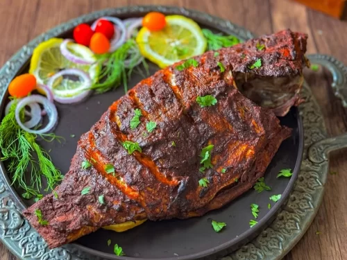 Houseboat at Alleppey backwaters during sunset, featuring palm trees and calm lagoons, romantic Kerala tour package.