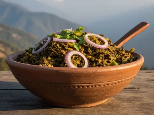 Gundruk, fermented leafy greens curry garnished with onion rings and cilantro, served in terracotta bowl against Himalayan backdrop, authentic Nepali-Sikkimese mountain delicacy.
