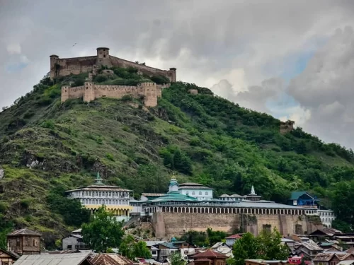Hari Parbat Fort hilltop with Takht Bhawani Temple Sharika Devi Shankaracharya Temple cloudy sky featured in Kashmir Srinagar tour packages