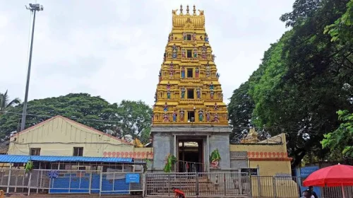 Sri Nimishambha Temple in Srirangapatna during daylight, featuring golden gopuram and lush greenery, perfect spiritual experience, Karnataka tour packages.