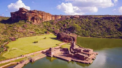 Badami Fort in Badami during daylight, featuring ancient fort ruins and Agastya Lake, perfect heritage experience, Karnataka tour packages.