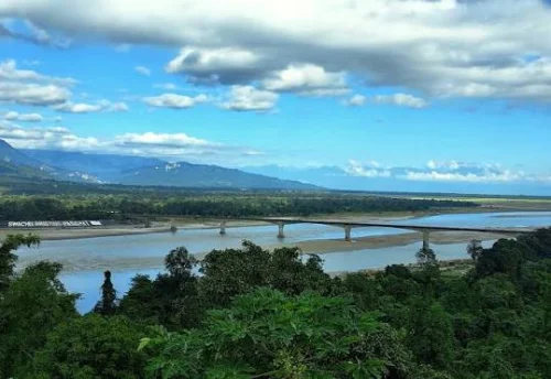 Ranaghat Bridge in Pasighat featuring wide river, concrete structure, and green hills, perfect Arunachal Pradesh tour package experience.