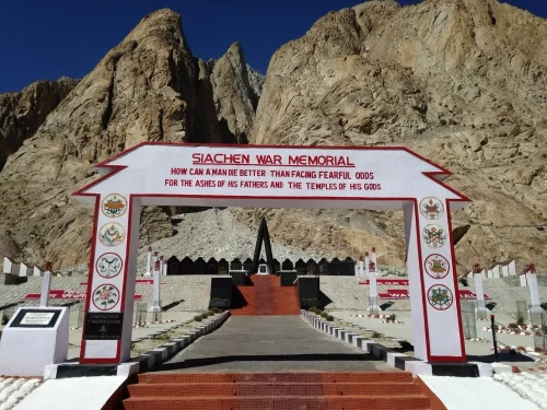 Siachen War Memorial gate at Siachen Base Camp in Ladakh during clear day, featuring arched sign, rocky peaks, perfect patriotic Siachen tour package. 