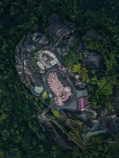 Aerial view of Jatayu Earth’s Center near Kovalam, Kerala, showcasing the massive eagle sculpture atop a rocky hill surrounded by lush greenery, a landmark attraction featured in Kerala tour packages.