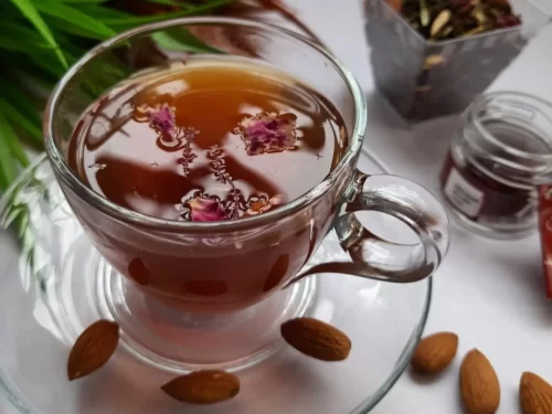 Kahwa in aromatic saffron-infused green tea with almonds and dried rose petals, traditional Indian Kashmiri beverage.