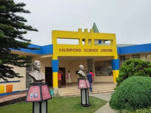 Kalimpong Science Centre in Kalimpong, West Bengal, featuring its colorful entrance with educational exhibits and statues at the front lawn, a family-friendly attraction included in West Bengal tour packages.