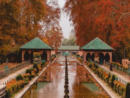 Kokernag Jammu Kashmir green pavilions autumn chinar trees red leaves reflecting water channel gardens Jammu Kashmir tour packages.