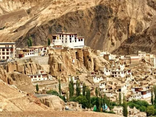 Lamayuru Monastery Ladakh close-up view of white gompa and clustered village buildings perched on dramatic eroded moonland cliffs amid barren Himalayan mountains, key stop on Leh Kargil highway in Lad