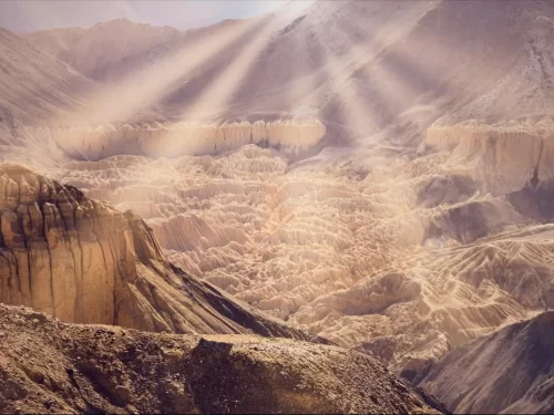 Lamayuru Moonland Ladakh dramatic sun rays illuminating eroded moonscape valleys and rugged Himalayan cliffs, iconic landscape near Lamayuru Monastery on Leh Kargil highway in Ladakh tour packages