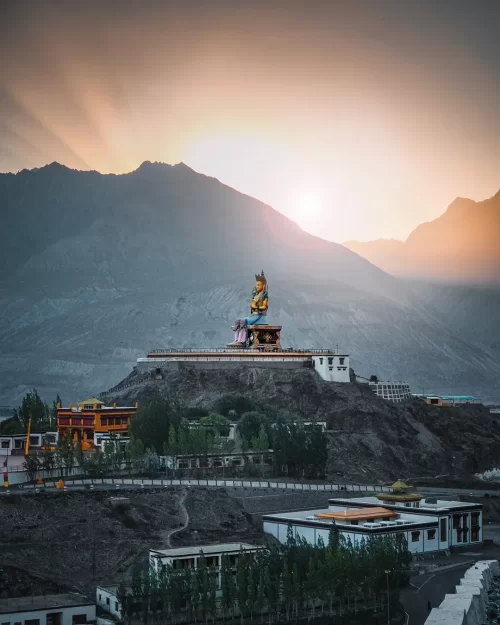 Diskit Monastery in Nubra Valley Ladakh with towering Maitreya Buddha statue at sunrise, a spiritual highlight in Ladakh tour packages