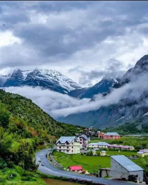 Scenic Jispa village in Himachal Pradesh with snow-capped mountains, lush valleys and winding road, a serene highlight in Himachal Pradesh tour packages